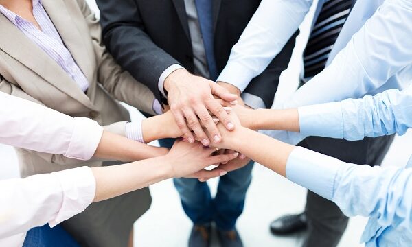 Business people joining hands in circle